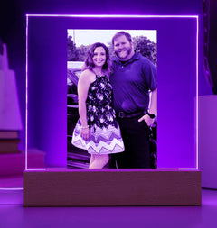 Acrylic photo frame with a purple neon border displaying a couple's photo.